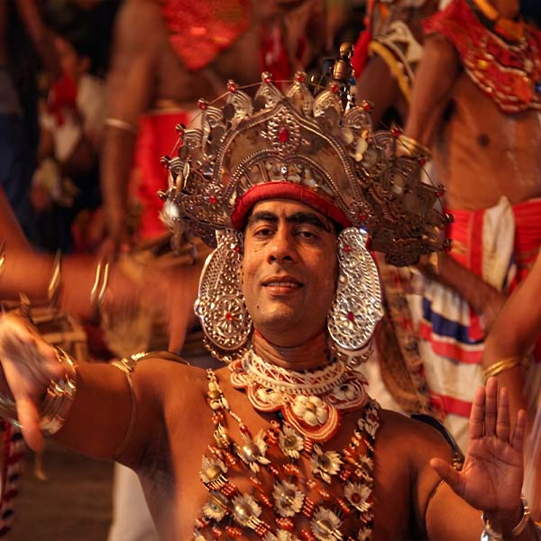 Traditional fire dancer performing at the Esala Perahera, featured in this Kandy city travel guide.