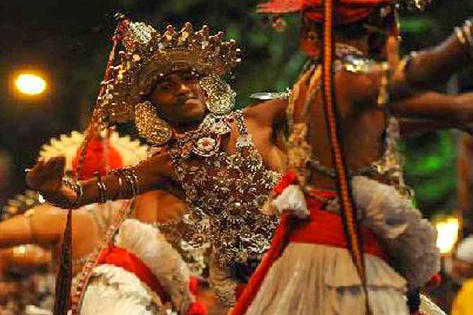 Beautiful Kandyan dancers are dancing to the rhythm of the Udarata drum.