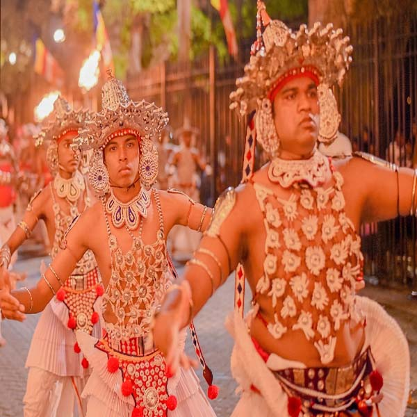 Kandyan dancer in traditional costume performing during the Kandy cultural procession.