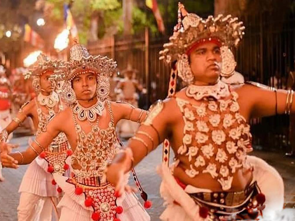 Kandyan dancer in traditional costume performing during the Kandy cultural procession.