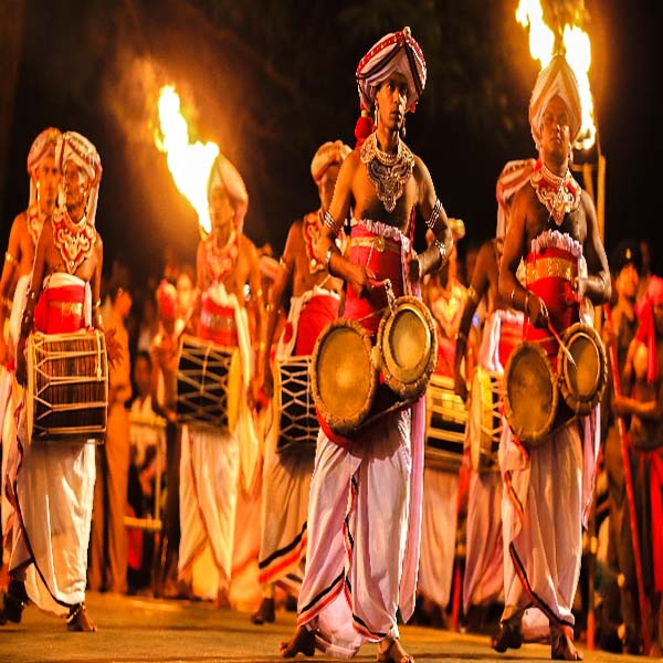 Traditional Sri Lankan drummer performing with a geta beraya during the Kandy Perahera.