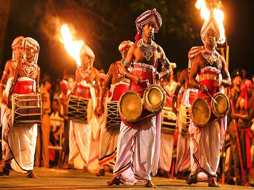 Traditional Sri Lankan drummer performing with a geta beraya during the Kandy Perahera.
