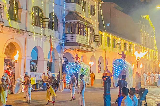 Group of traditional stick dancers participating in the Kandy Esala Perahera