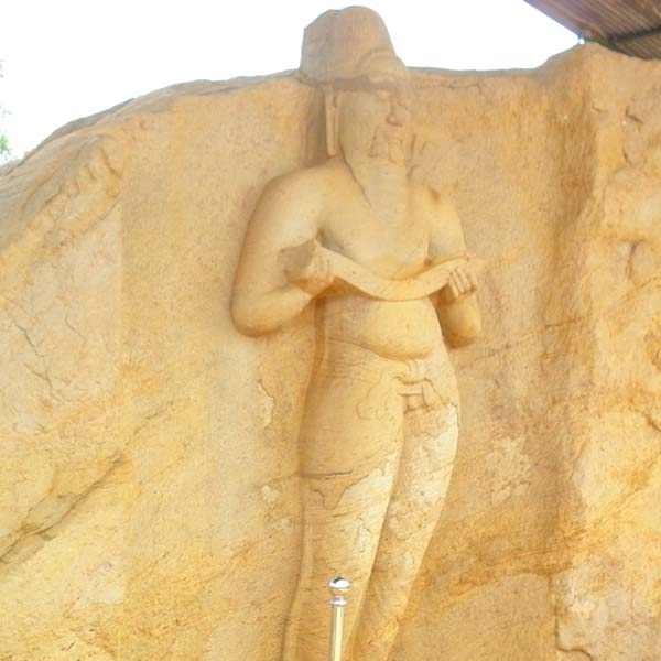 Stone statue of King Parakkramabahu the Great holding a puskola leaf manuscript at the ancient city of Polonnaruwa, Sri Lanka.