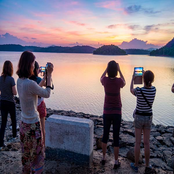 Tourists taking pictures of the expansive Parakkrama Samudraya reservoir in Polonnaruwa during a beautiful sunset