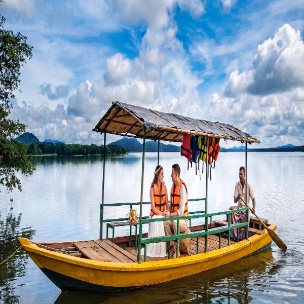 A scenic view of a boat ride on the historic Sorabora Wewa Lake in Mahiyanganaya.