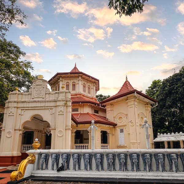 Ornate architectural carvings and decorative fence pillars at Asokaramaya Buddhist Temple in Thimbirigasyaya during a Colombo city tour