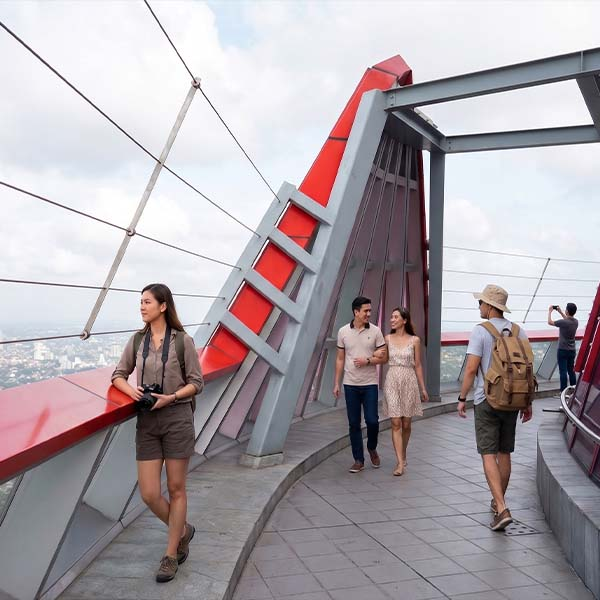 Tourists walking on the open-air observation deck of the Colombo Lotus Tower with panoramic views of the city skyline