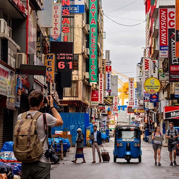 Tourist walking through bustling Pettah Market streets during a city tour in Colombo