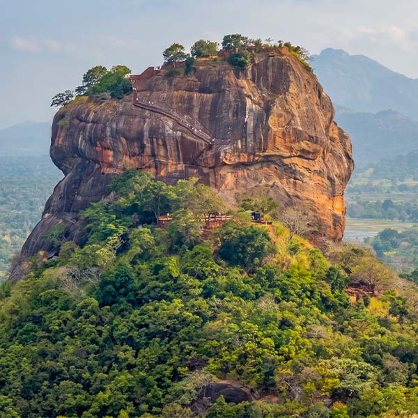 Sigiriya Lion Rock Fortress surrounded by lush green forests during a 10-day Sri Lanka tour