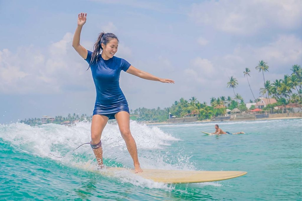 Surfer riding a wave on a surfboard in Arugam Bay Sri Lanka