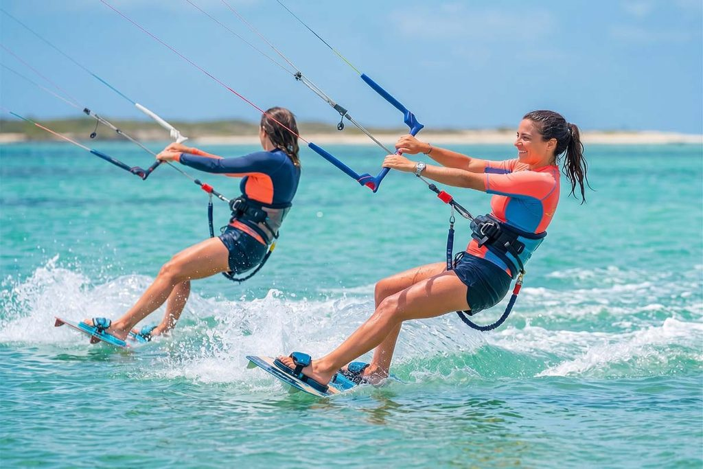 Two women kite surfing across the turquoise water during a 14-day Sri Lanka northern tour.